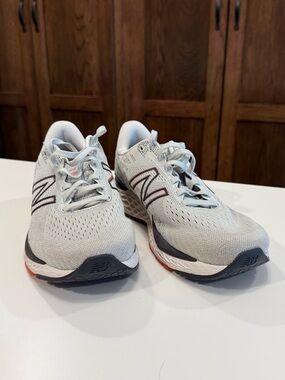 New Balance Mens Light Gray and Black Sneakers with Red Accents